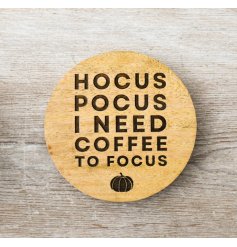 A natural wood round coaster with Halloween scripted text engraved.