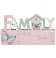 A wooden freestanding plaque adorned with pastel pink and green details, scripted text and butterflies