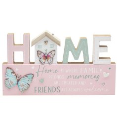 A cute shabby chic freestanding 'Home' plaque with butterfly decals and scripted text.