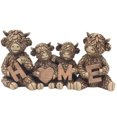 A wonderful ornament featuring a family of highland cows each holding a letter of the word 'home'.