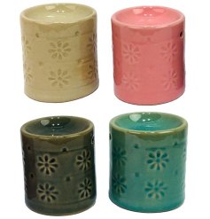 An assortment of 4 pretty oil burners each with a floral pattern around the side.