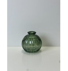 Made from coloured glass, this vintage bottle in a round shape would be sure to add a pop of colour to