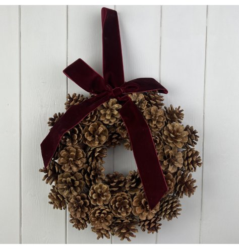 Adorn your home with a stunning pinecone wreath accented by a rich red velvet bow. Truly one-of-a-kind.