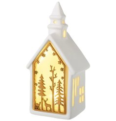 Decorate your holiday home with this adorable LED light house and add some festive cheer!