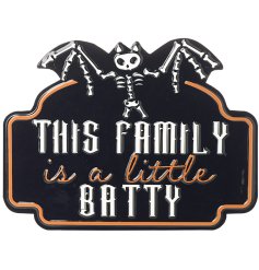 This family is a little batty. A humorous halloween themed metal sign with skeleton bat. 