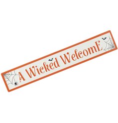 A large embossed sign in traditional orange, white and black halloween colours. 