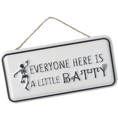 Everyone here is a little batty. A humorous monochrome metal sign with a skeleton illustration. 