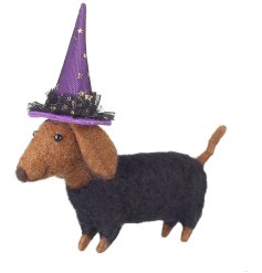 An adorable felt sausage dog dressed for halloween with a purple witches hat. 