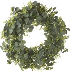 A rustic green foliage wreath dressed with artificial green foliage.