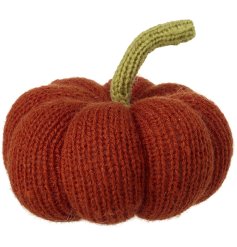 A warming burnt orange knitted pumpkin with green stalk. A chic seasonal decoration which will add colour and texture to