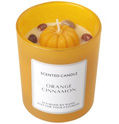 A colourful pumpkin style wax candle set within a glass jar. 