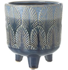 A stylish planter with a blue glaze and stylish leaf design. 