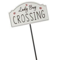 A unique garden stake with a cute and quirky Lady Bug Crossing sign. 