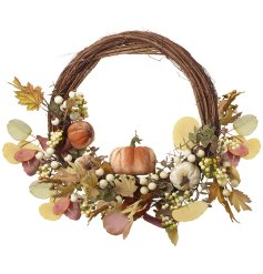 A rustic willow wrapped egg shaped wreath adorned with faux foliage, berries and artificial pumpkins. 