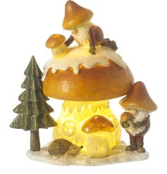 An enchanting woodland scene featuring a mushroom, gonks, tree and hedgehog. 