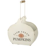 A rustic metal storage container in the shape of a pumpkin. Decorated with a rustic FARM FRESH slogan.