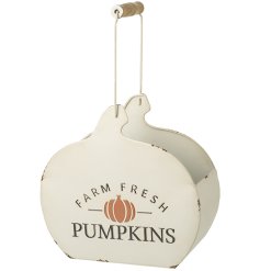 A rustic metal storage container in the shape of a pumpkin. Decorated with a rustic FARM FRESH slogan.