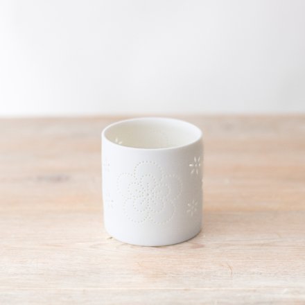 Made from porcelain, a chic white candle holder with flower detailing. 
