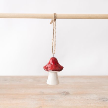 Finished with a clear glaze a simple red and white mushroom hanging decoration. 