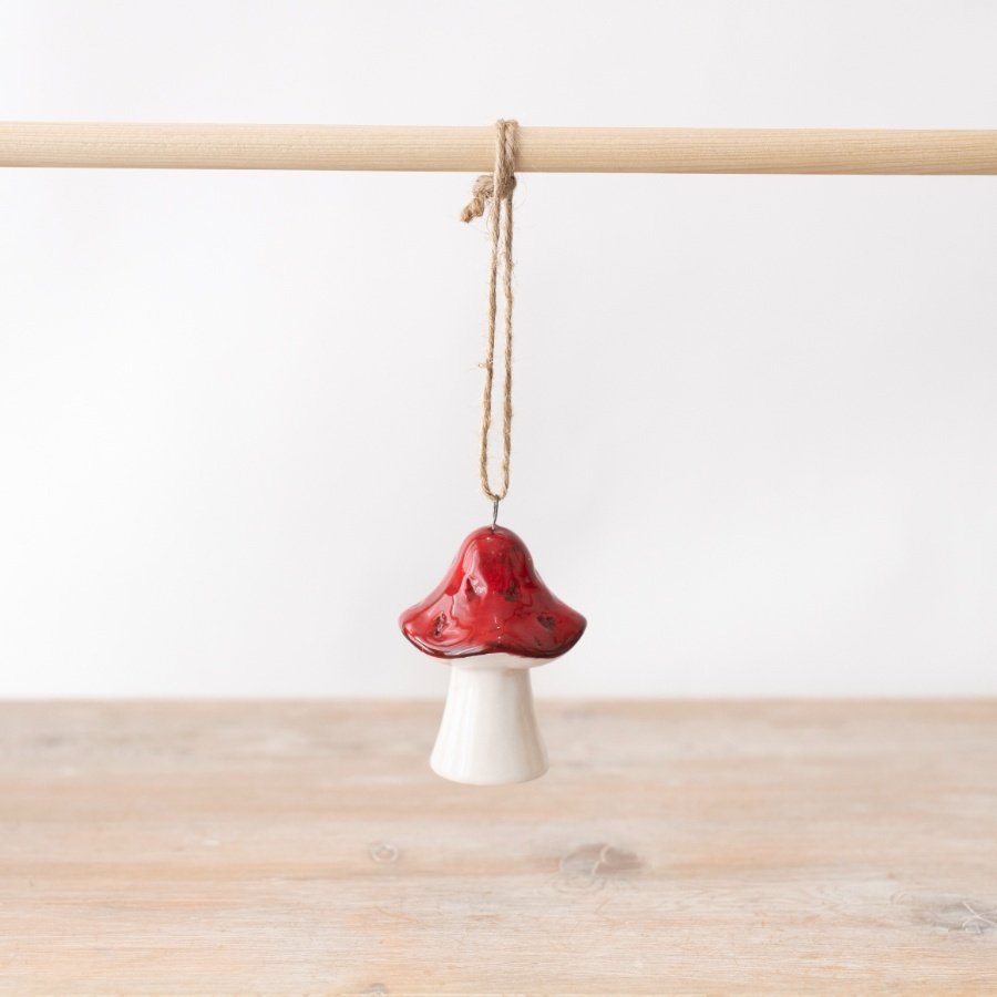 A mini hanging mushroom ornament in a deep red and white colour tone. 