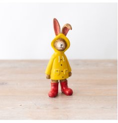 A cute little rabbit figurine wearing a yellow raincoat.