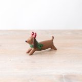 A cute and colourful dog ornament with spotty antlers and a stripy scarf. 