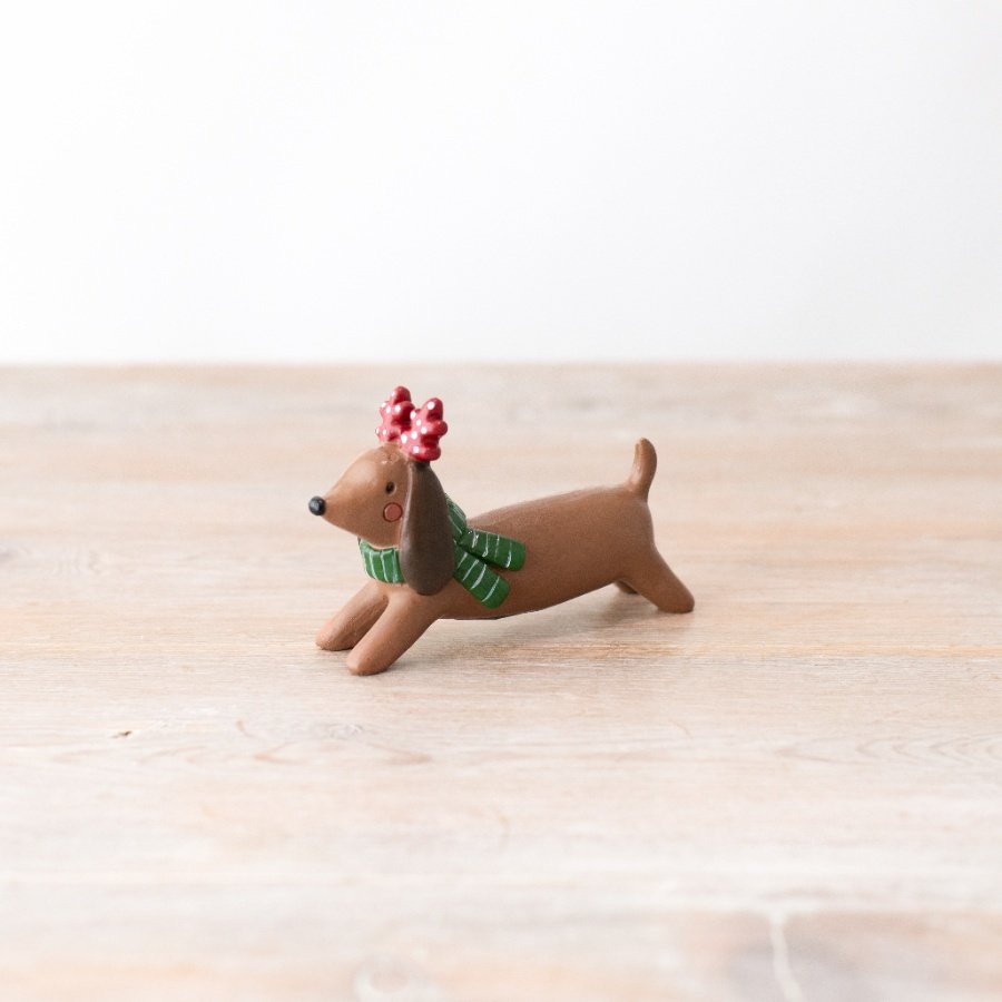 A charming and loveable dog ornament. Beautifully detailed with antlers and a scarf. 