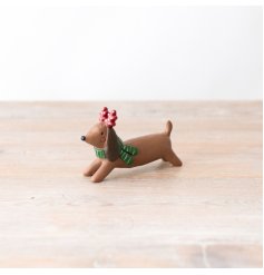 A cute and colourful dog ornament with spotty antlers and a stripy scarf. 