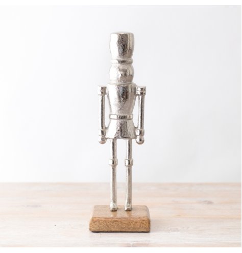 A chic and stylish nutcracker ornament in silver. Complete with wooden base