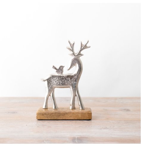 A silver reindeer ornament. Beautifully detailed with a textured surface and rustic base. 