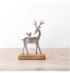 A chic silver reindeer ornament with a bird detail. Complete with a chunky rustic base.