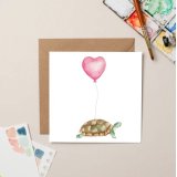 A charming Greeting card featuring a Tortoise with heart ballon