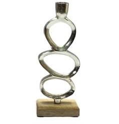 A brushed chrome effect candle stand with quirky oval details. 