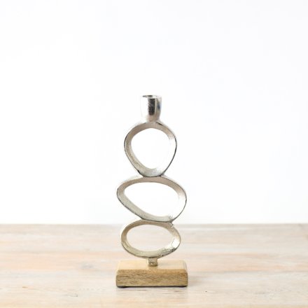 A brushed chrome effect candle stand with quirky oval details. 