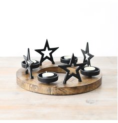 A round chunky t light holder made from metal and wood, detailed with 4 standing black stars and 4 t light holders