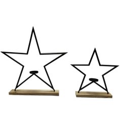 In jet black, this chic and modern candle holder features a star design and is set on a chunky wooden base.