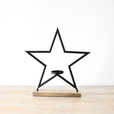 In jet black, this chic and modern candle holder features a star design and is set on a chunky wooden base.