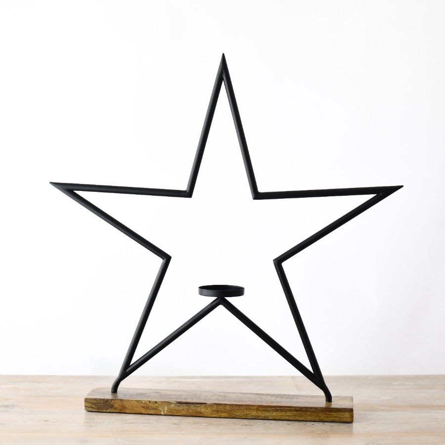 A modern style star t light holder in matte black. 