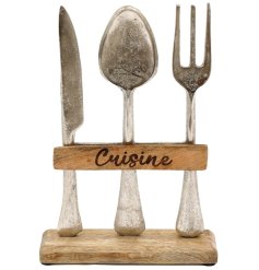 A simplistic kitchen ornament with 'Cuisine' engraved text and standing cutlery additions.