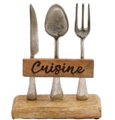 Set on a chunky wooden block, a kitchen ornament with 'Cuisine' wording and hammered