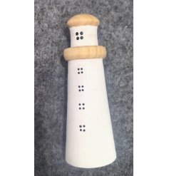 Enhance your decor with a charming coastal vibe using this adorable light house decoration.
