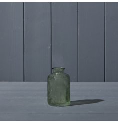 A beautiful glass bottle with a dimpled texture design, in vintage green. 