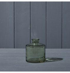 A squat glass bottle in a beautiful shade of vintage green.