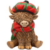 A cute Happy Highland Cow Ornament wearing a Tartan Hat.