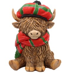 A cute Happy Highland Cow Ornament wearing a Tartan Hat.