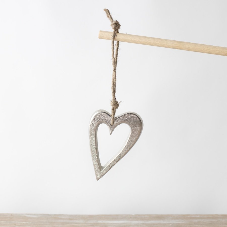 Add a charming touch to your decor with this lovely silver hanging heart. Perfect for refreshing your collection.