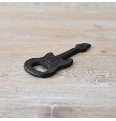 Handcrafted guitar-shaped bottle opener made from durable cast iron with a rustic finish. 