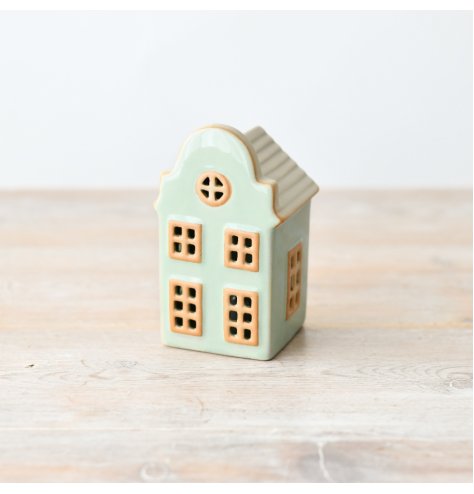 Adorable standing house decor in charming pastel green hue.