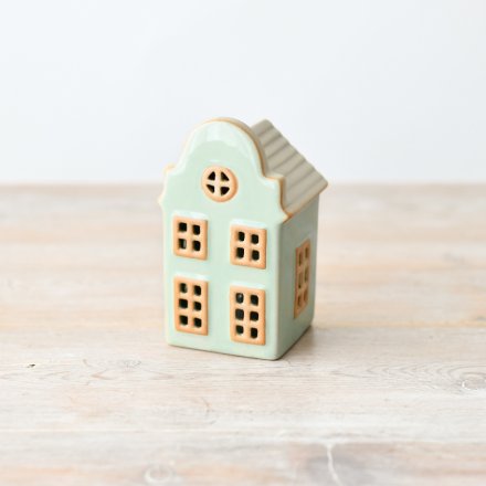 Adorable standing house decor in charming pastel green hue.