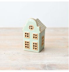 Charming pastel green standing house decoration with a delicate light 